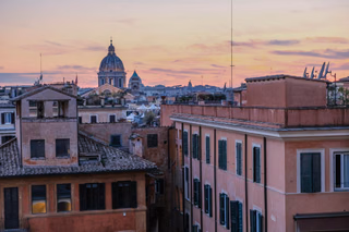 Rome rooftops and domes at sunset